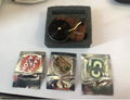 Miniature wooden turntable with player label and three different vinyl record stickers.