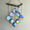 Rainbow hanging wall art decoration featuring colorful circular pendants on a wooden branch.